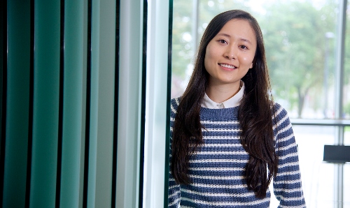 A foreign student standing and smiling